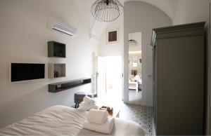 a bedroom with a bed with towels on it at Carlo Alberto Room in Fasano