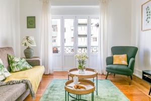 a living room with a couch and a chair at Casa da Avenida Lisboa in Lisbon