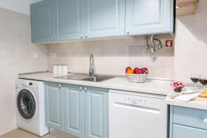 a kitchen with a sink and a dishwasher at Casa da Avenida Lisboa in Lisbon