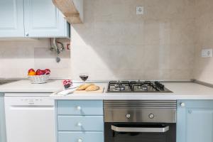 a kitchen with a stove and a plate of bread at Casa da Avenida Lisboa in Lisbon