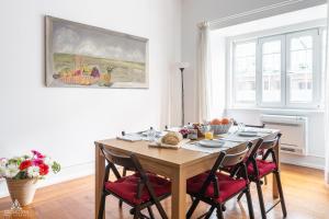 a dining room with a wooden table with chairs at Casa da Avenida Lisboa in Lisbon