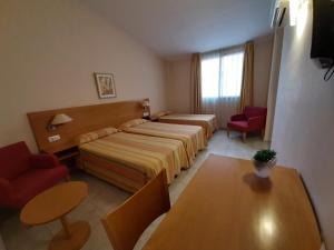 Postel nebo postele na pokoji v ubytování Hotel Rostits