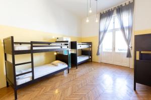 a room with three bunk beds and a window at Spicy Hostel in Budapest