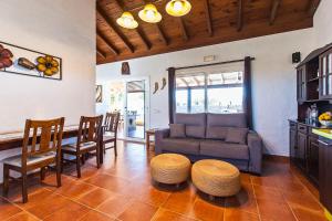 a living room with a couch and a table and chairs at VISTAMALPEI in Cotillo