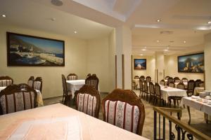 a restaurant with tables and chairs in a room at Accommodation Marija 2 in Kotor