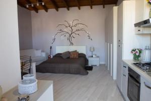 a bedroom with a bed and a tree on the wall at L'Alberata dei Sogni in Frosinone