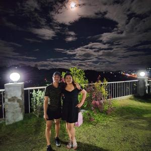 two women are posing for a picture at night at 723 Moonlight Place 321-FREE WIFI in Antipolo