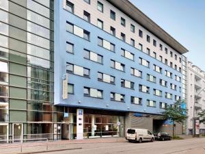 a blue building with a white van parked in front of it at ibis budget Hamburg St Pauli Messe in Hamburg