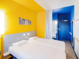 Ein Bett oder Betten in einem Zimmer der Unterkunft ibis budget Genève Aéroport