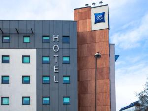 a building with a blue sign on the side of it at ibis budget London Hounslow in Hounslow