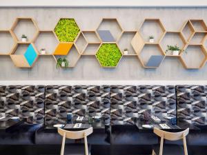 a rendering of a restaurant with tables and chairs at ibis Deira Creekside Dubai in Dubai