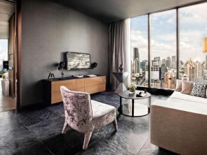 a living room with a couch and a chair at SO/ Bangkok in Bangkok