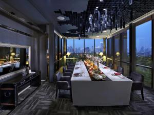 a long dining room with a long table with chairs at SO/ Bangkok in Bangkok