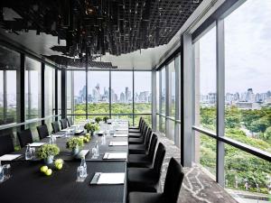 a long dining room with long tables and chairs at SO/ Bangkok in Bangkok