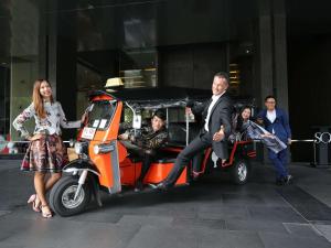 a group of people sitting in a golf cart at SO/ Bangkok in Bangkok