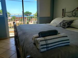 a bedroom with a bed with two towels on it at Wave View Village - Beach Front - Luxury Spot in Rincon