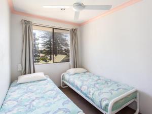 a bedroom with two beds and a window at Oxley 8 at Tuncurry in Tuncurry