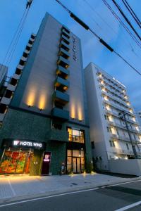 a hotel building with a store in front of it at Hotel Wing International Select Hakata-Ekimae in Fukuoka