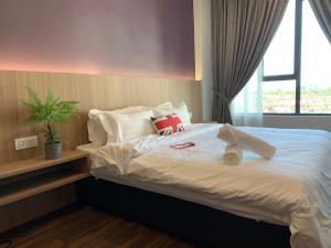 a bedroom with a large white bed with a window at 3Bedroom Rex Apartment 5min Drive to Vivacity in Kuching +7 photos