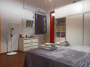 1 dormitorio con 1 cama con vestidor y ventilador en BELLA CASA 110m2 - CENTRO - PATIO - PARRILLA en Rosario