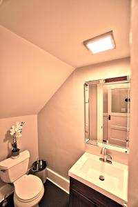 y baño con aseo, lavabo y espejo. en Newly Renovated Stunning Space, en Savannah