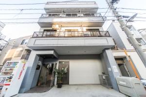 a building with a balcony on top of it at nestay suite tokyo tabata 03 in Tokyo