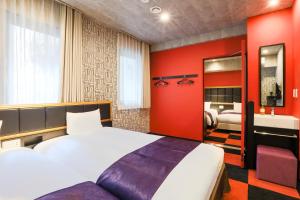 a hotel room with a bed and a bathroom at Hotel Wing International Select Hakata-Ekimae in Fukuoka