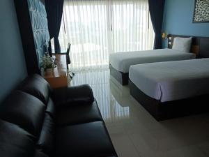 Postel nebo postele na pokoji v ubytování Phuket Chinoinn-SHAPlus Certified