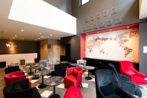a waiting room with red chairs and a world map on the wall at Hotel Wing International Select Hakata-Ekimae in Fukuoka
