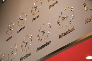 a wall with numbers and clocks on it at Hotel Wing International Select Hakata-Ekimae in Fukuoka