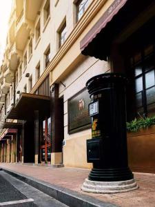 a black pole on a street in front of a building at Jinjiang Metropolo Hotel Classic Nanjing Road (East) Shanghai in Shanghai