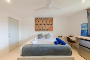 a bedroom with a bed with blue pillows on it at Art Studios in Cancún
