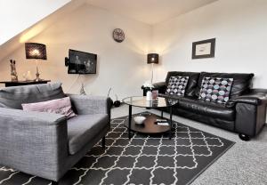 a living room with two couches and a table at Apartments mit Flair in Fehmarn