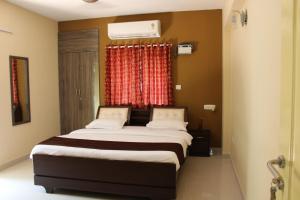 a bedroom with a large bed with a window at Phoenix Serviced Apartment - Sai Illam in Chennai