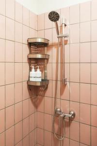 a shower in a bathroom with a shower head at Villa Baba By The Villas 100 in Puncak