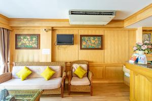 a room with two chairs and a couch and a tv at Silver Gold Garden, Suvarnabhumi Airport in Lat Krabang