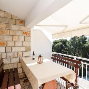 a dining room with a table and chairs on a balcony at Apartments Villa Ana in Gornji Dingač