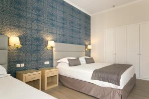 Postel nebo postele na pokoji v ubytování Thermae Sylla Spa & Wellness Hotel
