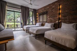 A bed or beds in a room at Sementra Hot Spring Nature Resort