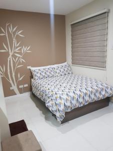 a bedroom with a bed with a pillow and a window at Skymagz 314 at Cityscape Residences in Bacolod