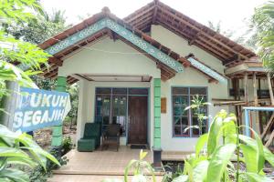 a small house with a sign in front of it at Homestay Mbah Parni in Sermo