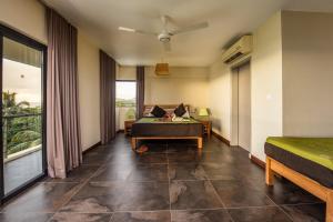 a hotel room with a bed and a window at Happy Days Guest House in Le Morne