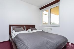 Posteľ alebo postele v izbe v ubytovaní Jantar Apartamenty- Zielone Tarasy