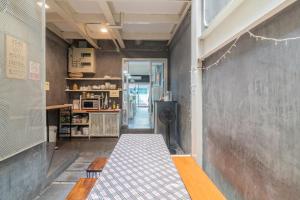 a room with a bench and a chalk wall at On the Bed Hostel in Bangkok