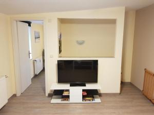 a living room with a flat screen tv on a tv stand at Ferienwohnung 2 in Nähe der Ostsee in Grevesmühlen