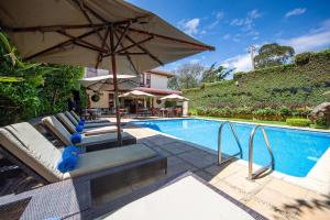 a patio area with a pool, chairs, and a pool table at African Tulip in Arusha