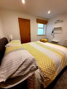 a bedroom with a bed with a stuffed animal on it at In the heart of Portrush - Beautiful Views in Portrush