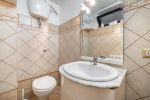 a bathroom with a sink and a toilet at Villa Martina in Costa Rei +22 photos