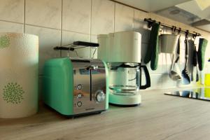 a green and white toaster sitting on a kitchen counter at Whg./flat am Großen Garten in Dresden in Dresden