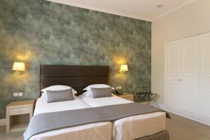Ένα ή περισσότερα κρεβάτια σε δωμάτιο στο Thermae Sylla Spa & Wellness Hotel 
